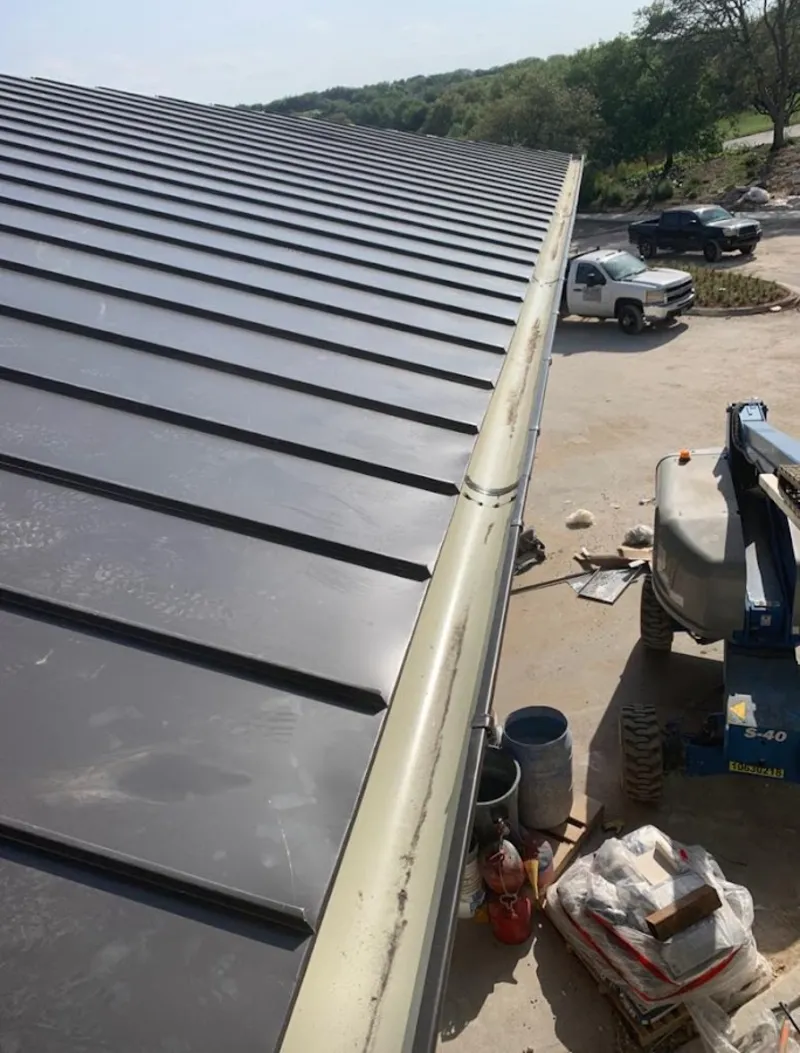 Standing seam panel and gutter detail on a metal roofing jobsite in Sans Souci